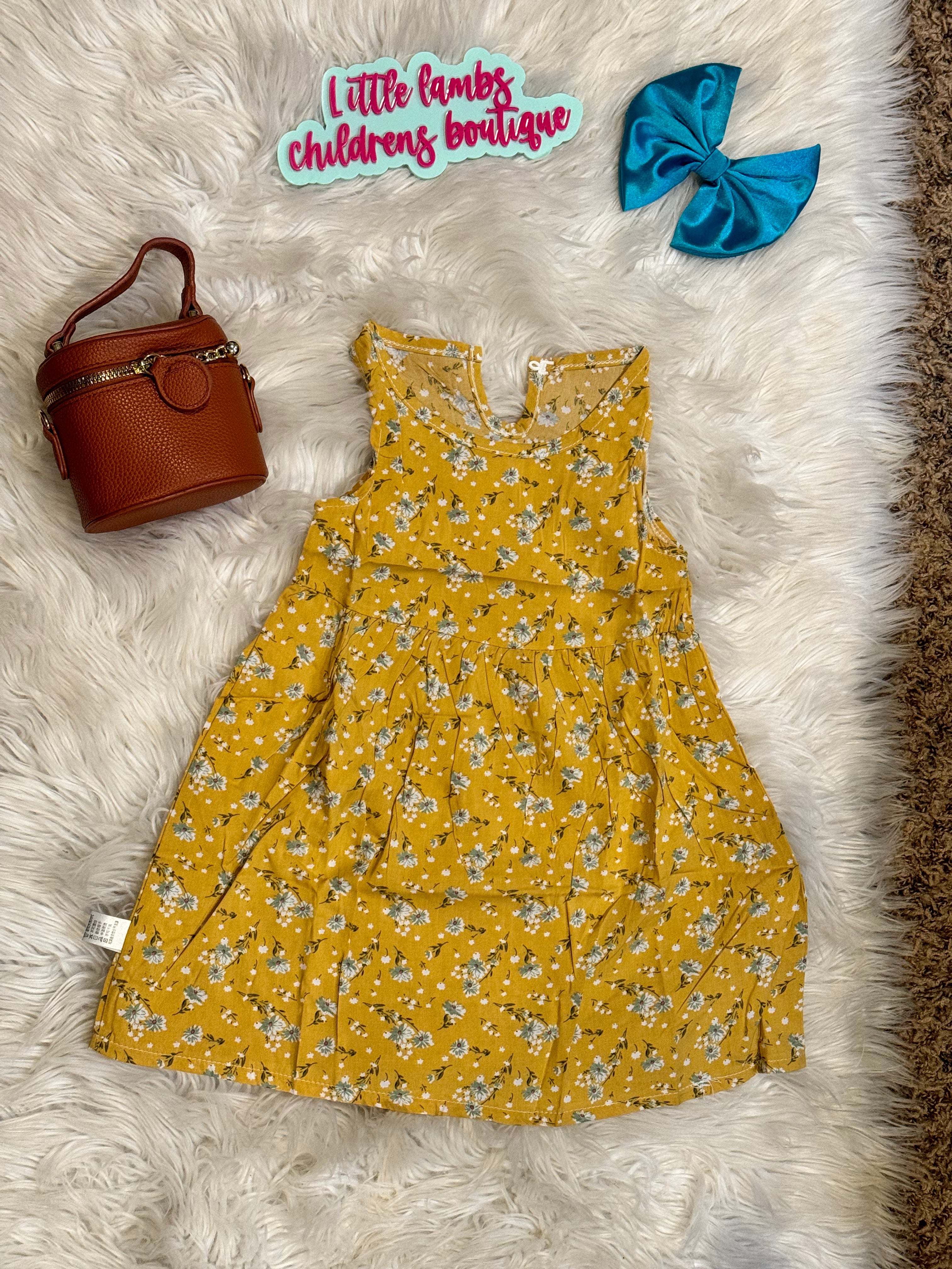 Yellow dress with blue flowers โ Little Lambs Childrenโs Boutique Missouri
