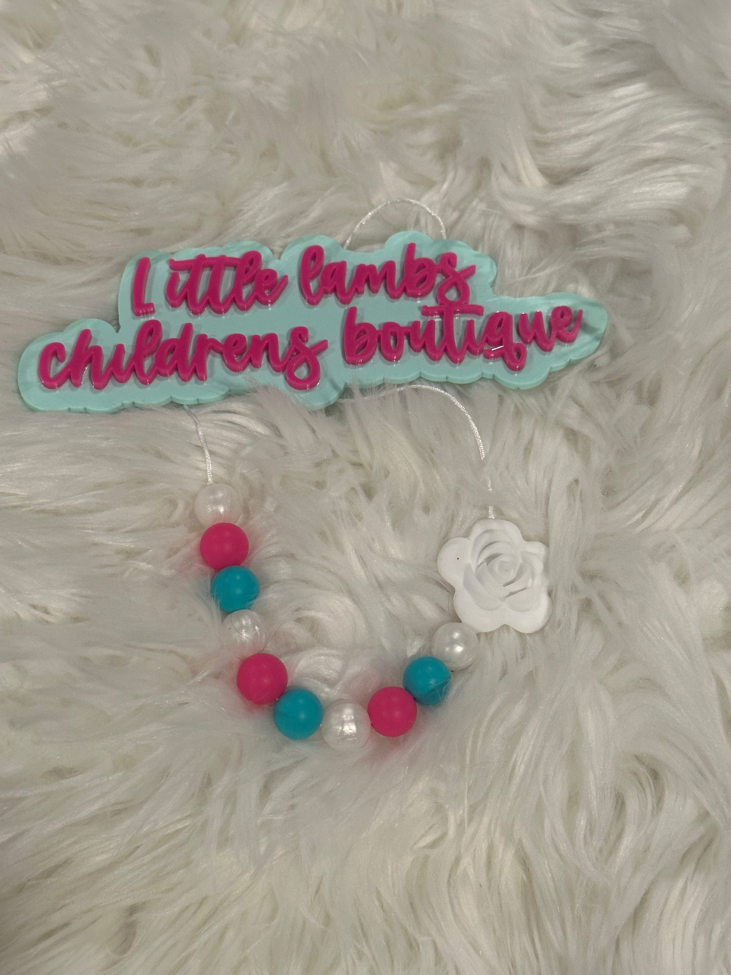 Baby silicone necklace with pink, blue, white and flower